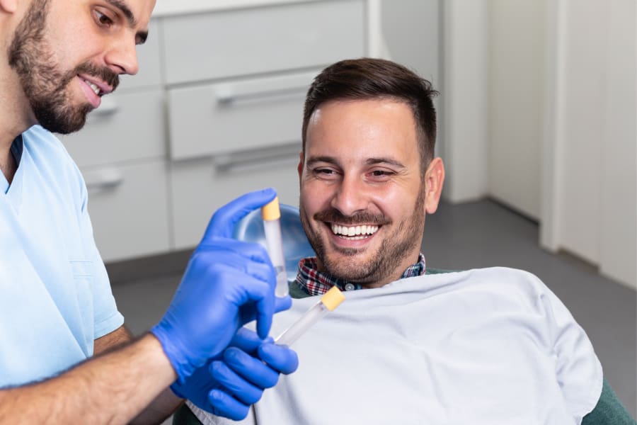 Doctor showing a vial of serum to a male patient