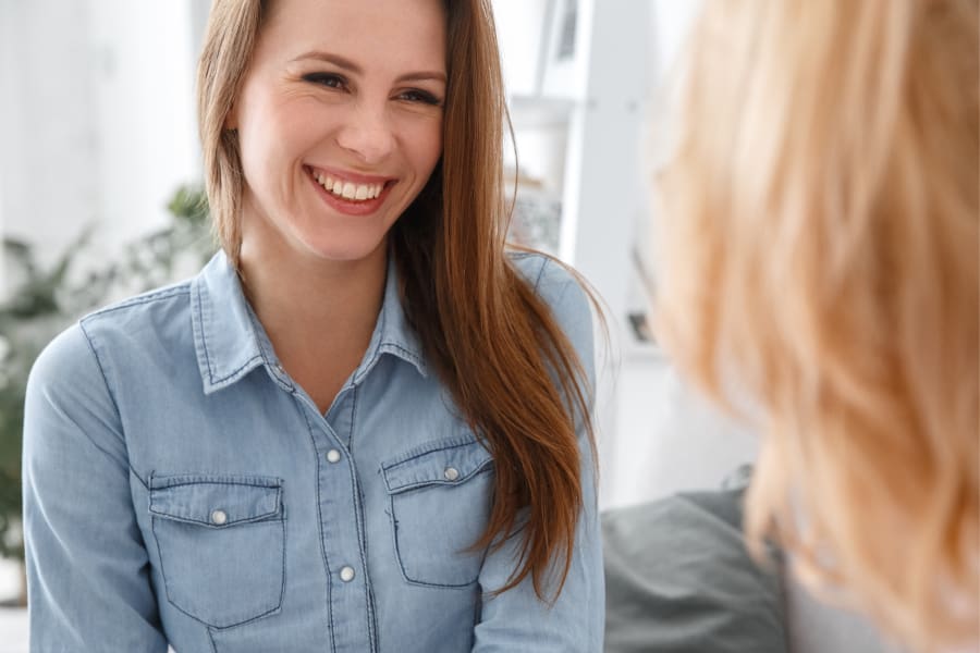 Primary Care - Smiling woman having a conversation with her doctor