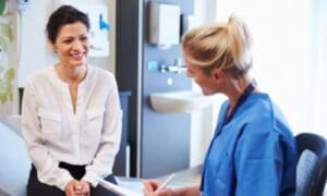 Non-surgical treatment - A doctor examining a female patient's neck patient