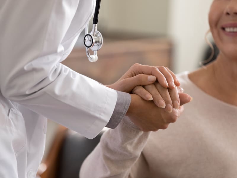 Doctor holding the hand of a female patient