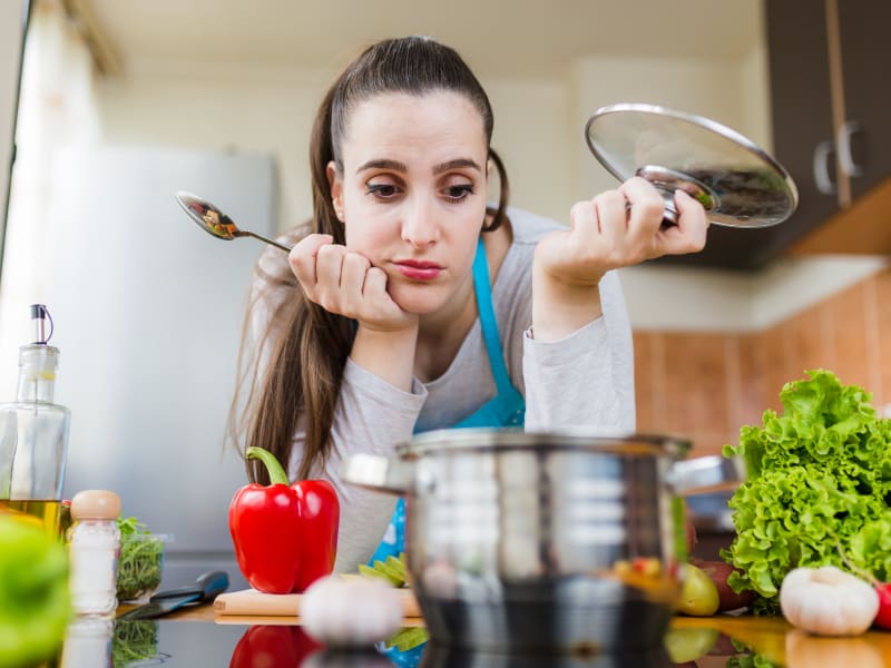 Woman looking bored trying to plan a meal